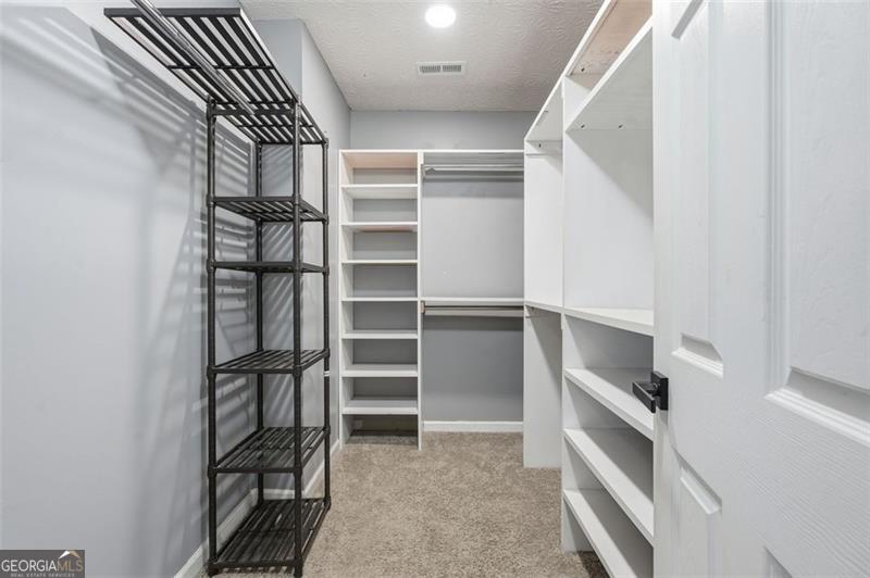 4450 Dorsett Shoals Road Douglasville, GA 30135 - Photo 26 of 36 a view of walk in closet with empty racks