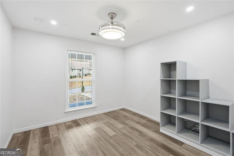 4450 Dorsett Shoals Road Douglasville, GA 30135 - Photo 30 of 36 wooden floor in an empty room with a window