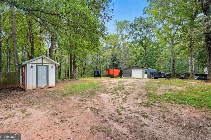 4450 Dorsett Shoals Road Douglasville, GA 30135 - Photo 35 of 36 a front view of a house with a yard and trees