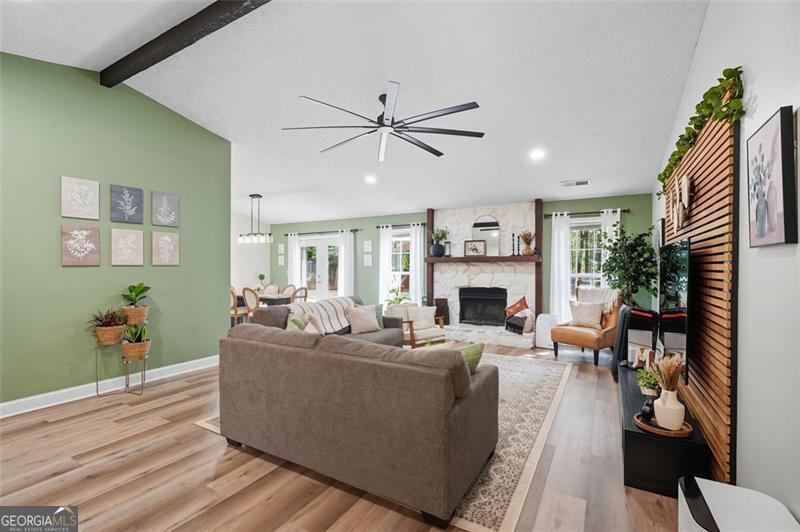 4450 Dorsett Shoals Road Douglasville, GA 30135 - Photo 5 of 36 a living room with furniture a fireplace and a potted plant