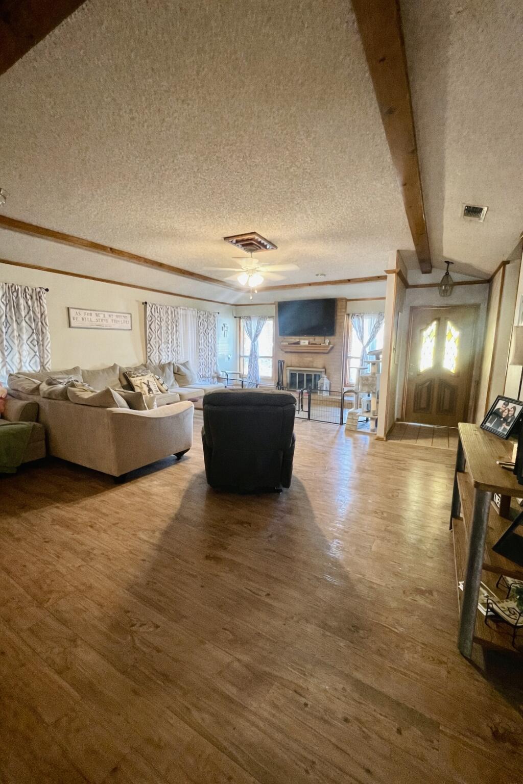 5725 63rd Street Lubbock, TX 79424 - Photo 2 of 14 a room with wooden floors and furniture