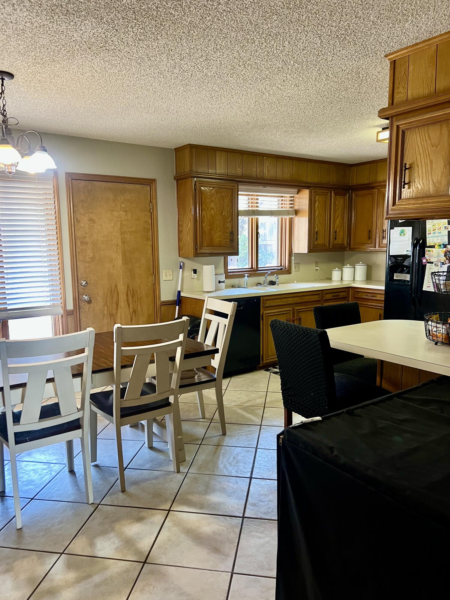 5725 63rd Street Lubbock, TX 79424 - Photo 5 of 14 a kitchen with a dining table and chairs