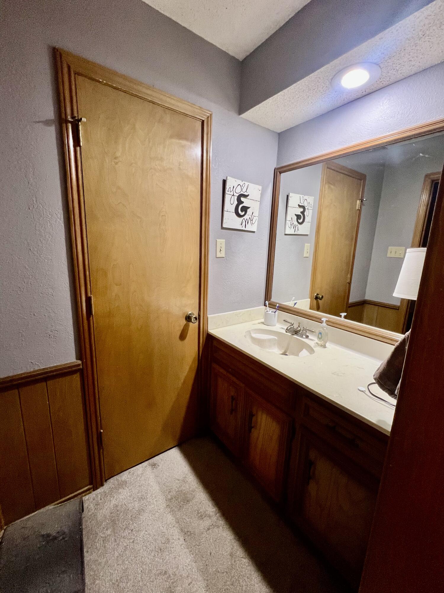 5725 63rd Street Lubbock, TX 79424 - Photo 8 of 14 a bathroom with a sink a mirror and a shower