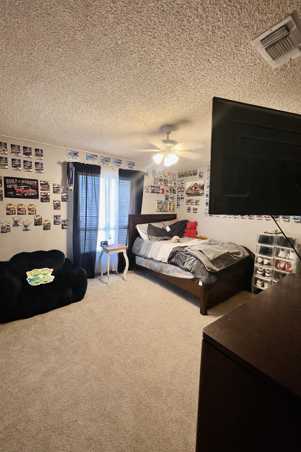 5725 63rd Street Lubbock, TX 79424 - Photo 9 of 14 a bedroom with bed and a flat screen tv