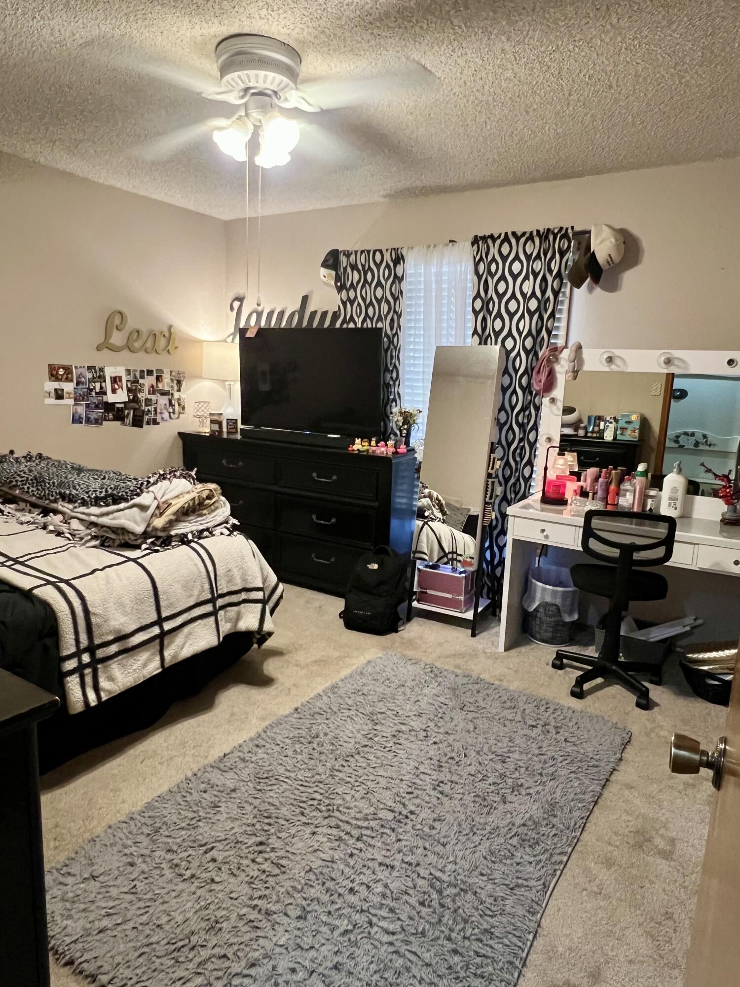 5725 63rd Street Lubbock, TX 79424 - Photo 10 of 14 a bedroom with a bed gym equipment and view of living room