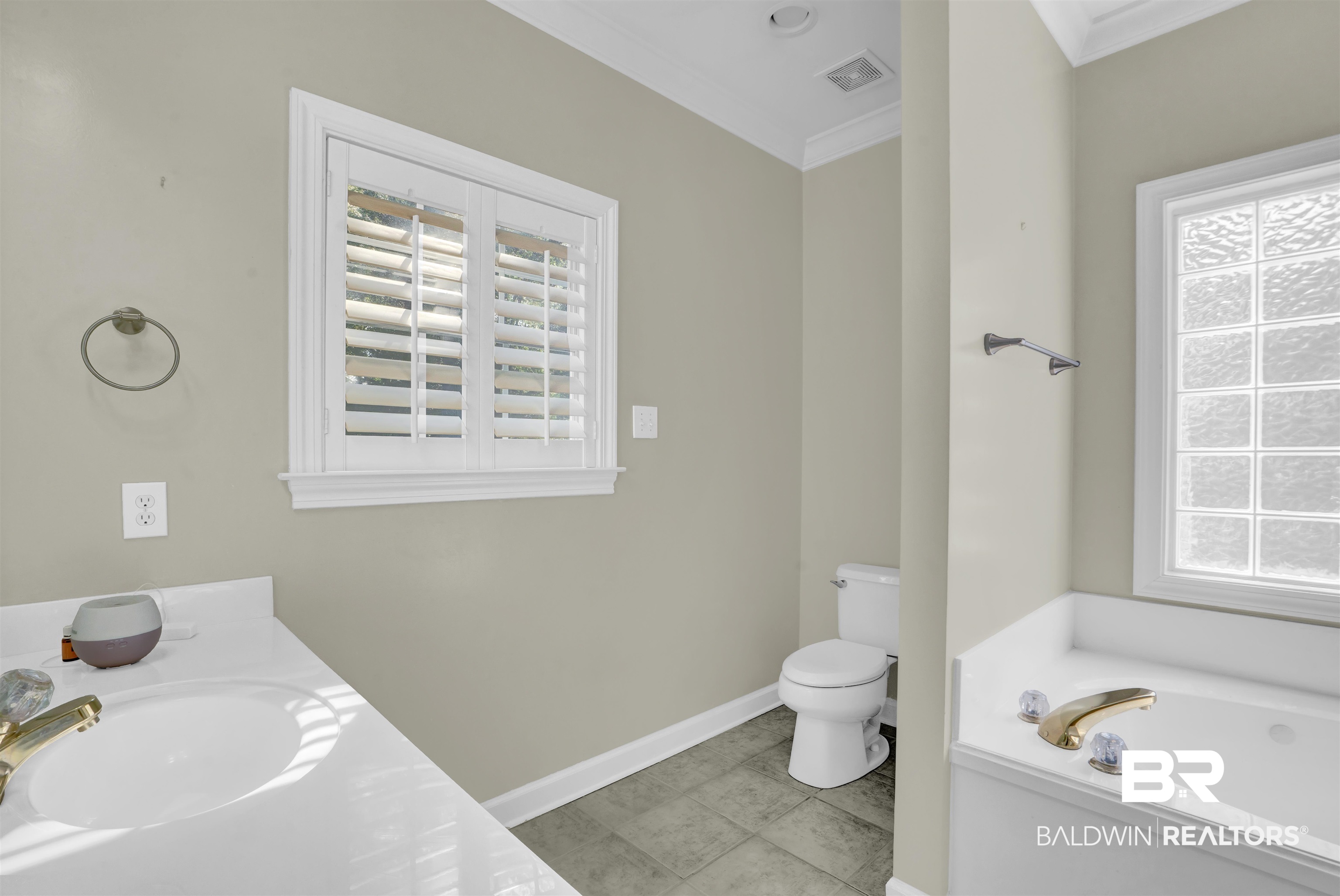111 Beaver Dam Road Fairhope, AL 36532 - Photo 34 of 51 Bathroom with ornamental molding, tile patterned flooring, a washtub, and toilet