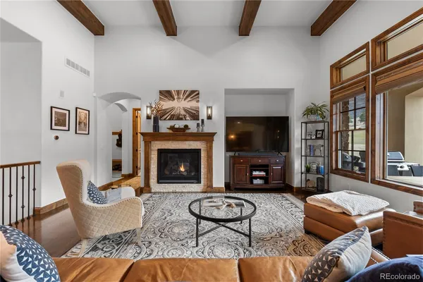 a living room with furniture a flat screen tv and a fireplace