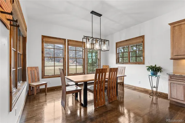 a view of a dining room with furniture window and wooden floor