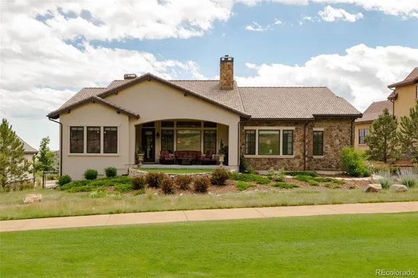 a front view of a house with a garden and plants