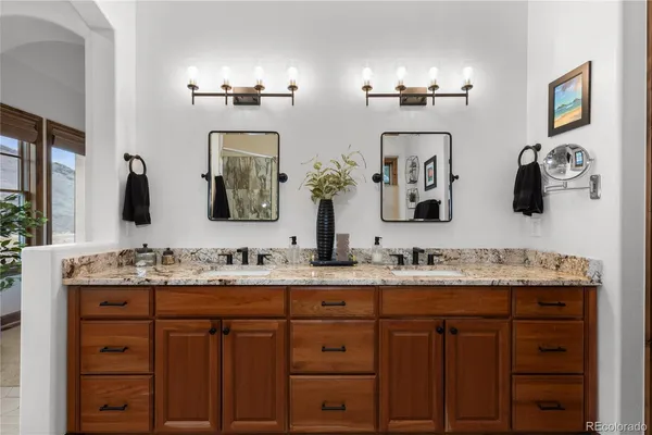 a bathroom with double sink and a mirror