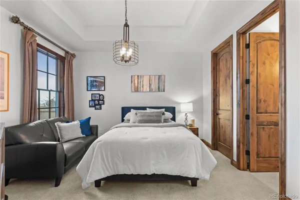 a spacious bedroom with a bed and window