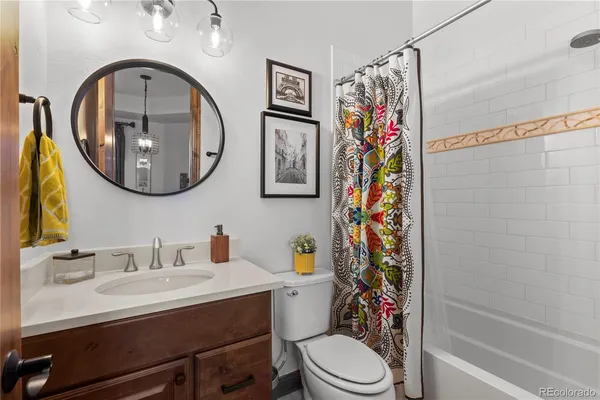 a bathroom with a sink a mirror and a toilet