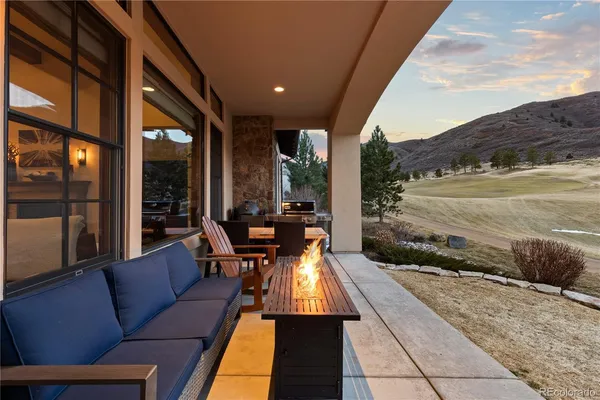 a view of terrace with seating area and mountain view