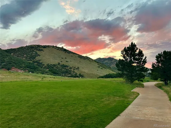 a view of grassy field with mountain in the background