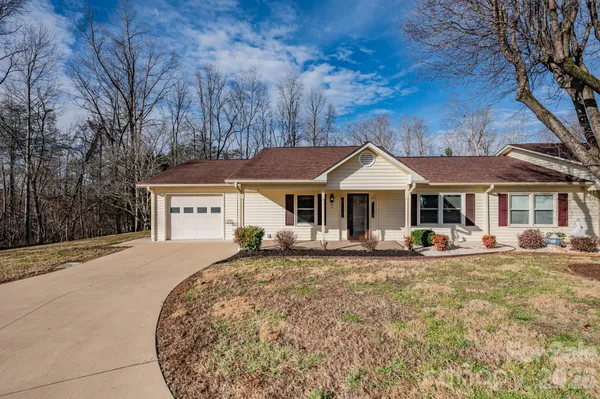 a front view of a house with sitting area and garden