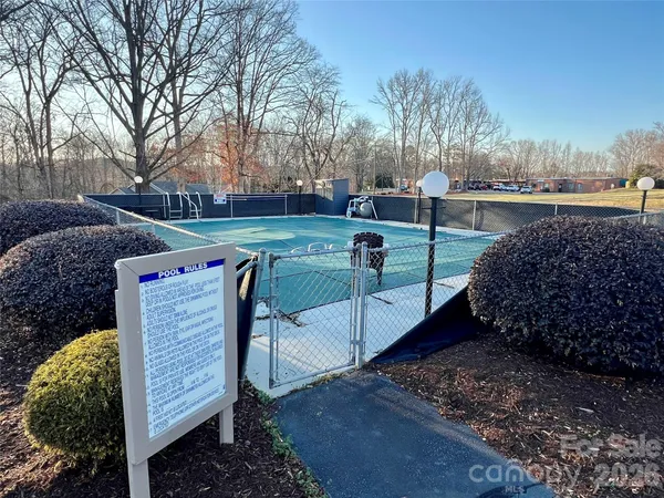 a view of a chairs and table in the backyard
