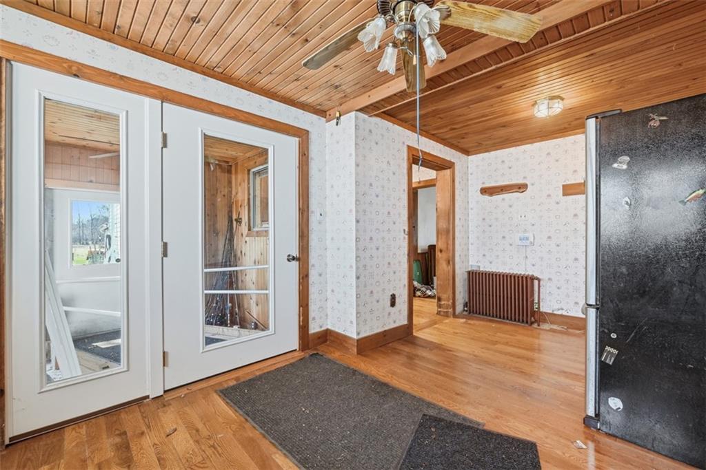 7524 Franklin Road Cranberry Township, PA 16066 - Photo 12 of 44 a view of a hallway with wooden floor and a bathroom