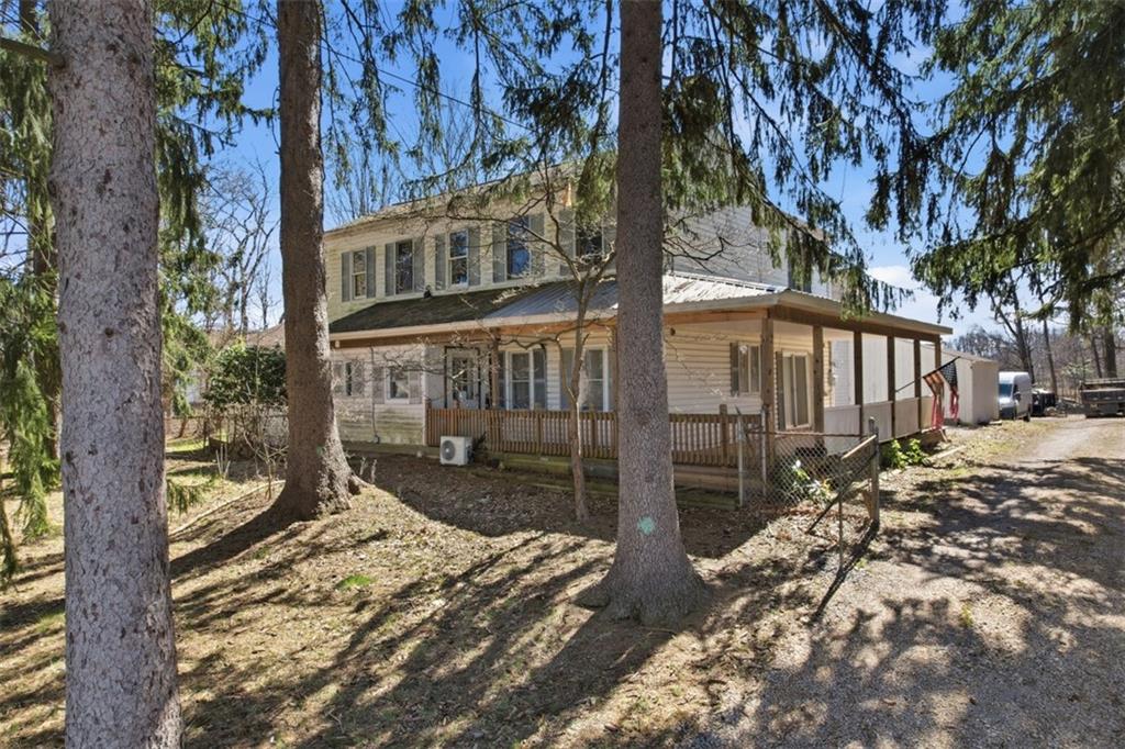 7524 Franklin Road Cranberry Township, PA 16066 - Photo 3 of 44 a backyard of a house with large trees and wooden fence