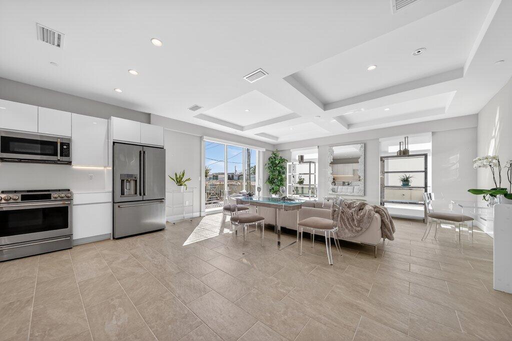 41 Southwest Seminole Street, Unit 209 Stuart, FL 34994 - Photo 11 of 26 a living room with furniture large window and flat screen tv
