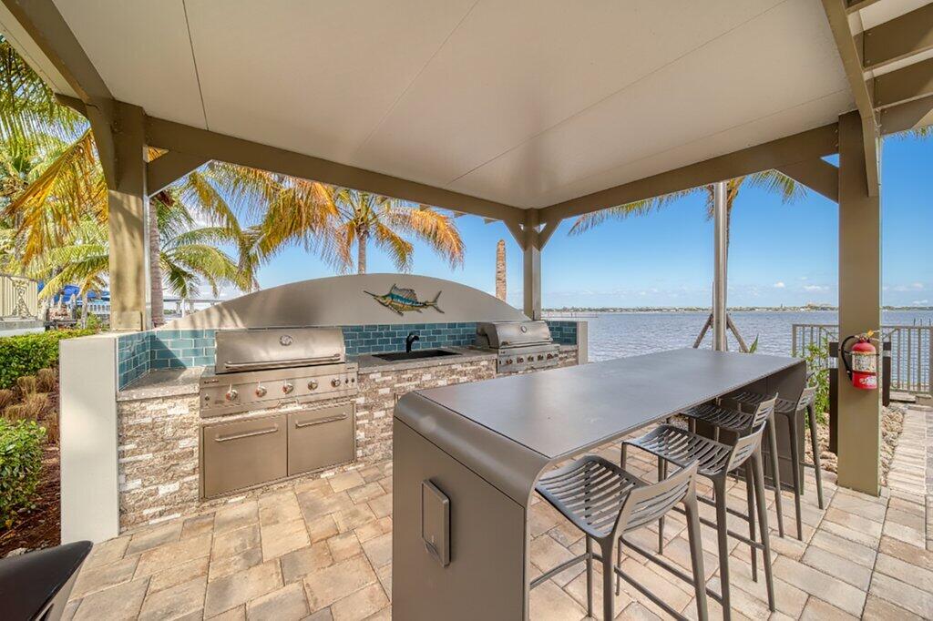 41 Southwest Seminole Street, Unit 209 Stuart, FL 34994 - Photo 18 of 26 a kitchen with stainless steel appliances a sink a stove and a refrigerator