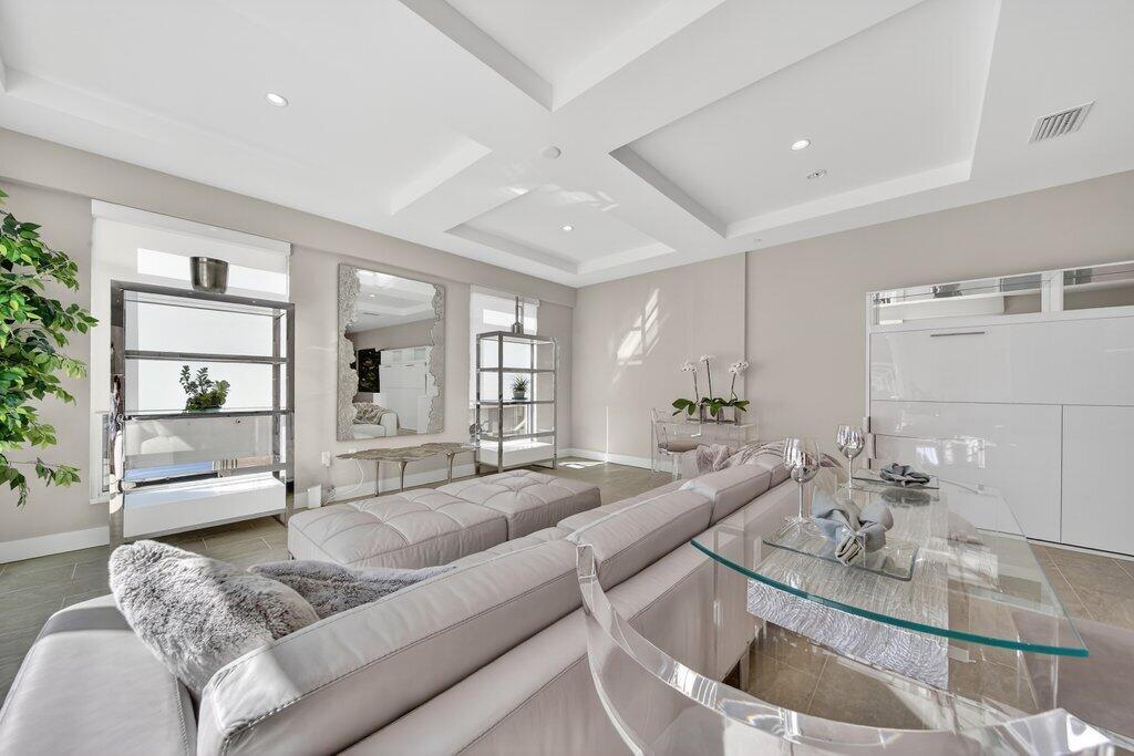 41 Southwest Seminole Street, Unit 209 Stuart, FL 34994 - Photo 2 of 26 a living room with furniture and a large window