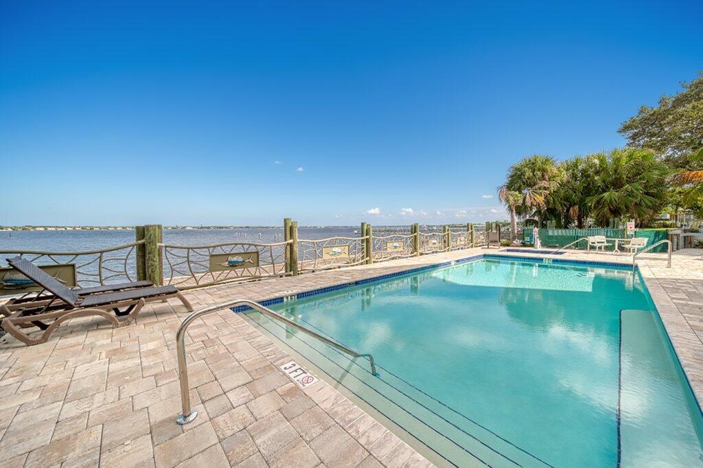 41 Southwest Seminole Street, Unit 209 Stuart, FL 34994 - Photo 21 of 26 a view of a swimming pool with an outdoor seating