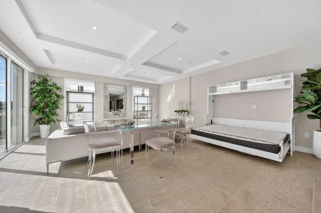 a living room with furniture a rug and a large window