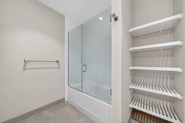 a bathroom with a bathtub and a shower