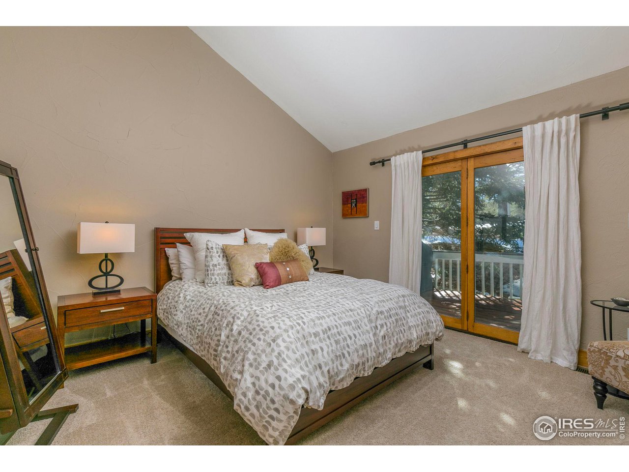 1933 Interlocken Drive Evergreen, CO 80439 - Photo 18 of 40 Main level primary suite with access to the large deck and vaulted ceilings