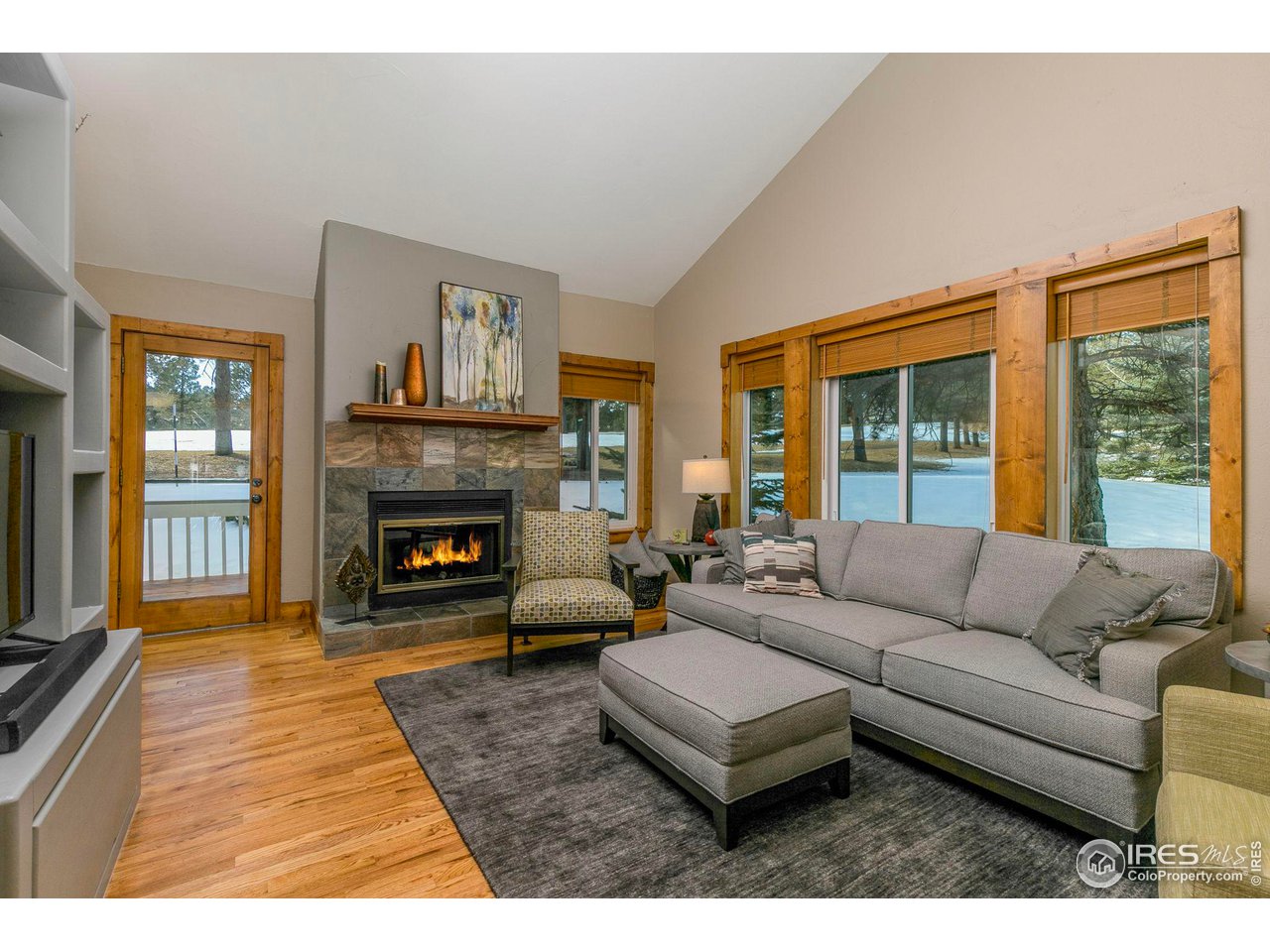 1933 Interlocken Drive Evergreen, CO 80439 - Photo 8 of 40 Living room with views of the golf course. Enjoy cozy nights by the fire