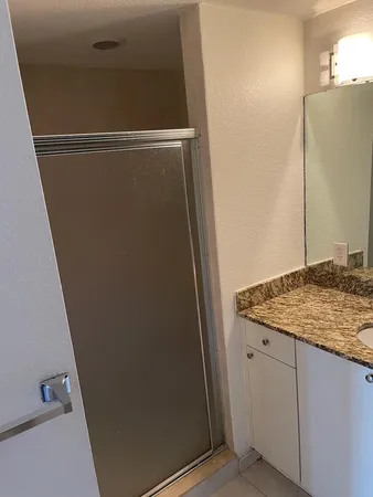 a bathroom with a granite countertop sink and vanity