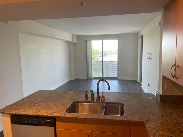 a kitchen with a sink a stove and cabinets