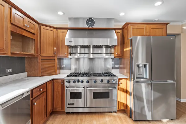 a kitchen with stainless steel appliances granite countertop a sink and stove