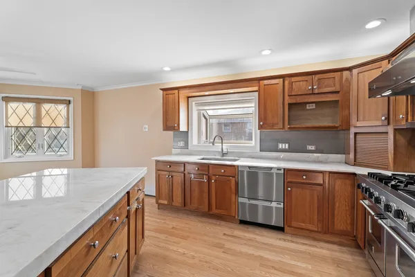 a kitchen with stainless steel appliances granite countertop a stove and a refrigerator