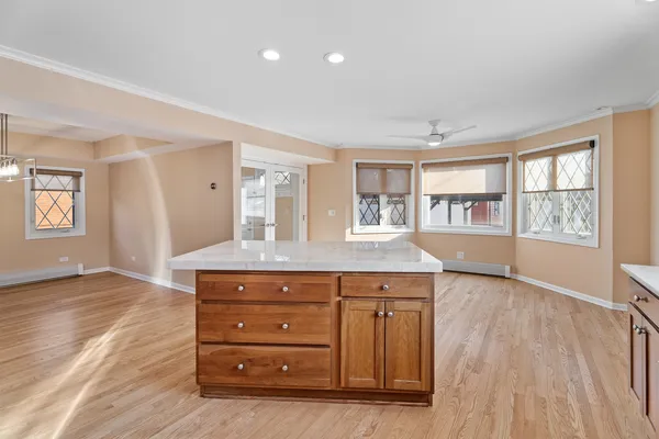 a large kitchen with kitchen island a sink stainless steel appliances and cabinets