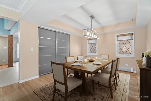 an empty room with wooden floor cabinet and windows