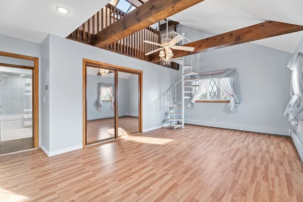 a view of a livingroom with wooden floor and window