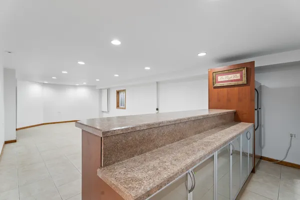 a living room with furniture pool table and window