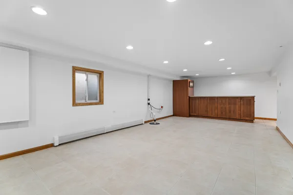 an empty room with fan and windows