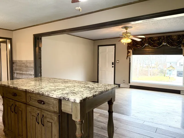 a view of a hallway with wooden floor and windows