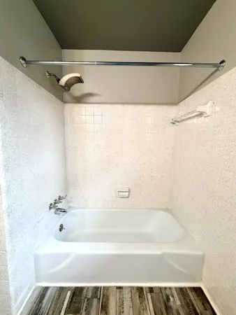 a bathroom with a shower and a bath tub