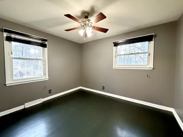 a view of room with window and ceiling fan