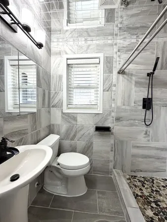 a bathroom with a toilet sink and a shower