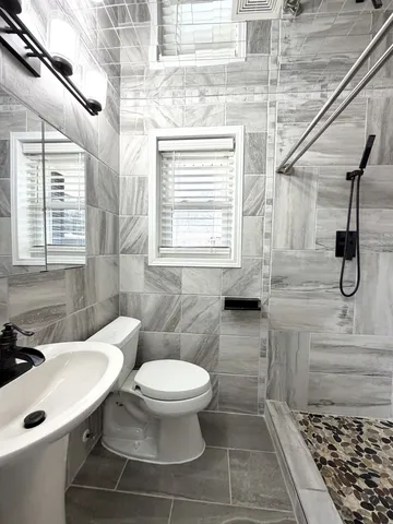 a bathroom with a toilet sink and a shower