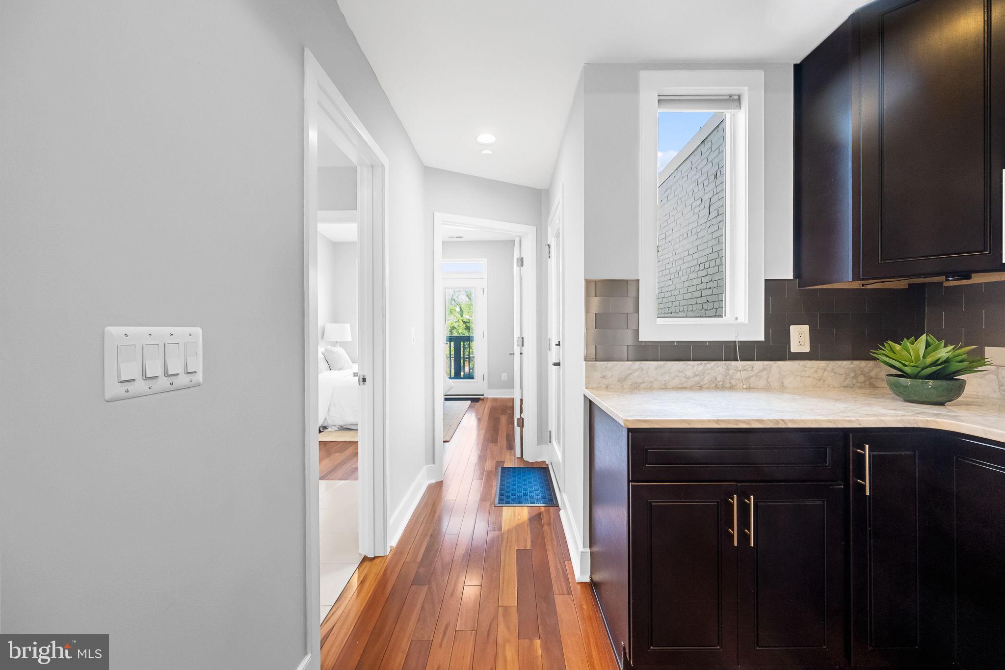 2819 11th Street Northwest, Unit 2 Washington, DC 20001 - Photo 13 of 36 a kitchen with a sink and wooden floor