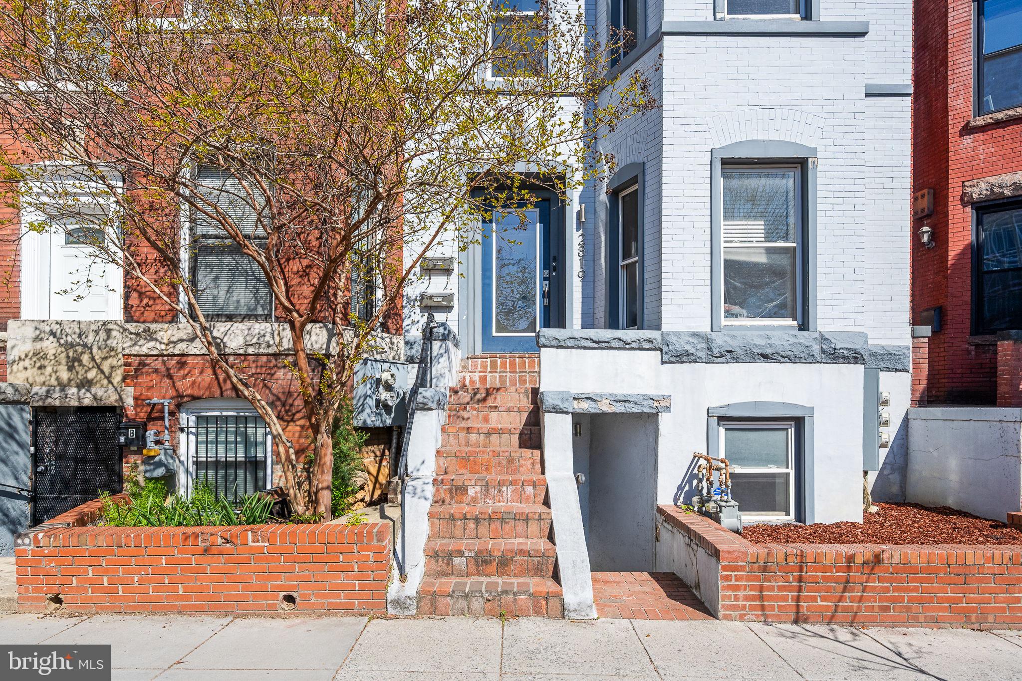 2819 11th Street Northwest, Unit 2 Washington, DC 20001 - Photo 2 of 36 front view of a brick house with a small yard