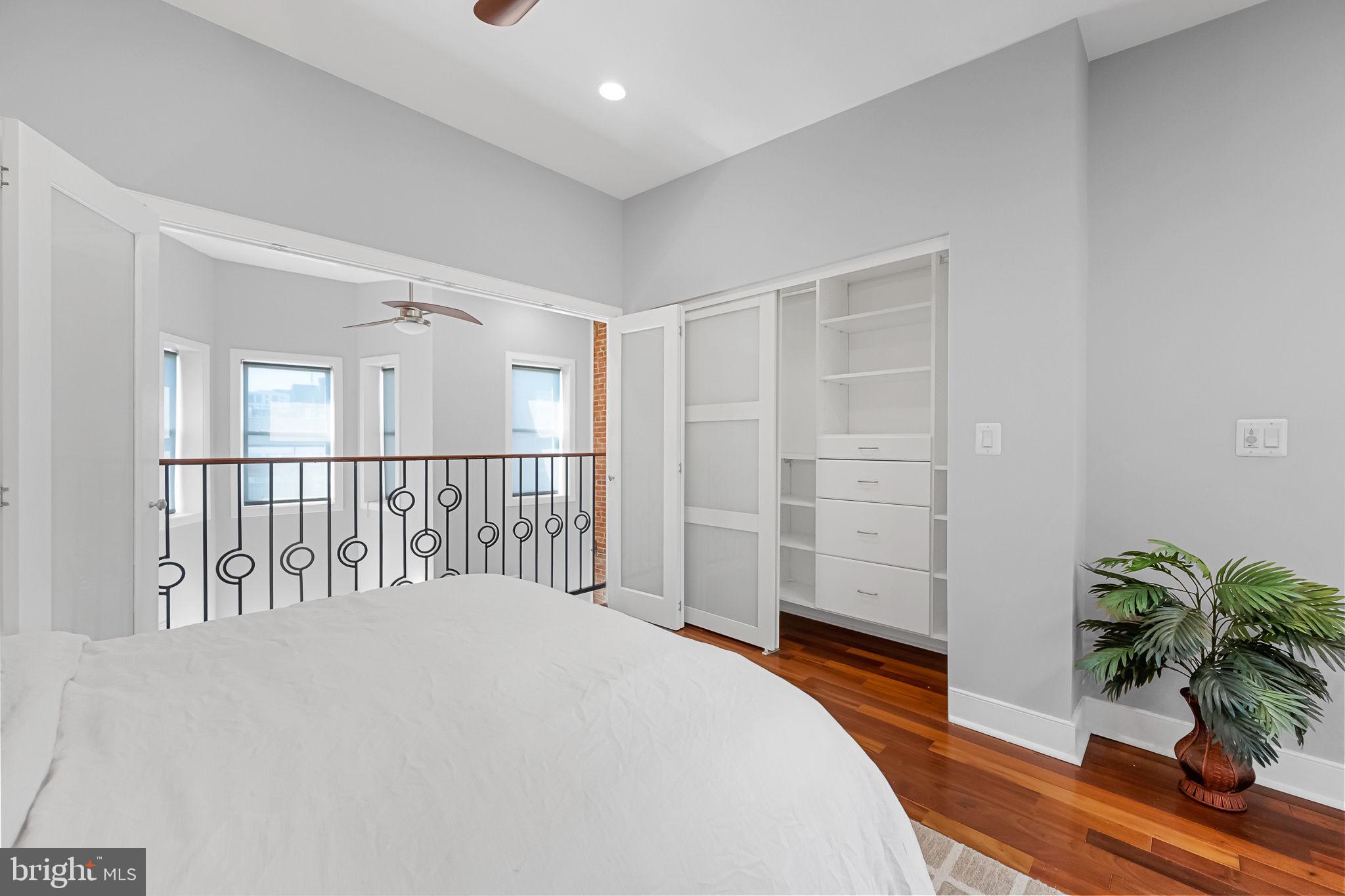 2819 11th Street Northwest, Unit 2 Washington, DC 20001 - Photo 25 of 36 a bedroom with a large bed and a potted plant