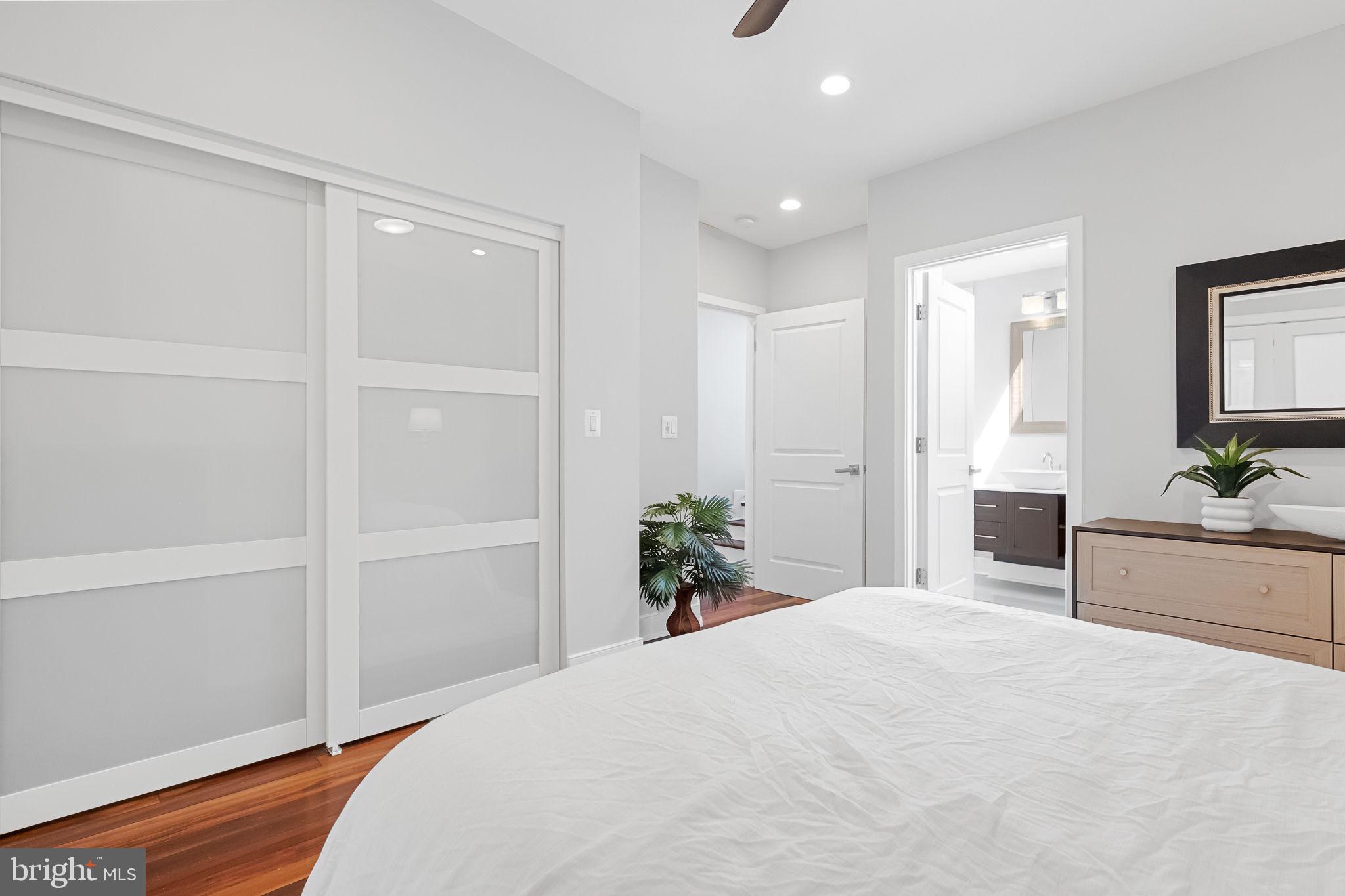 2819 11th Street Northwest, Unit 2 Washington, DC 20001 - Photo 26 of 36 a bedroom with a large bed and chandelier