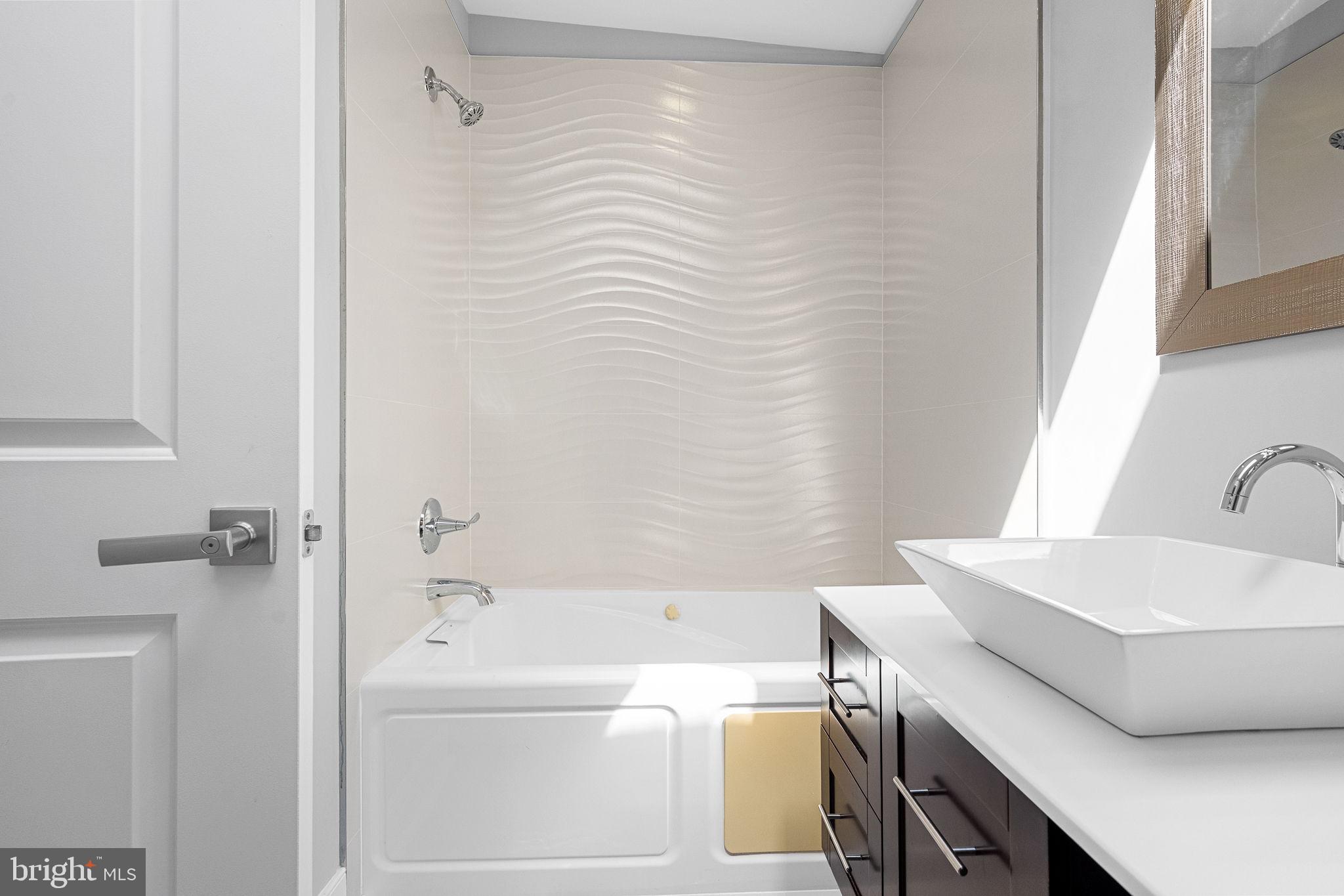 2819 11th Street Northwest, Unit 2 Washington, DC 20001 - Photo 30 of 36 a bathroom with a sink and a bathtub