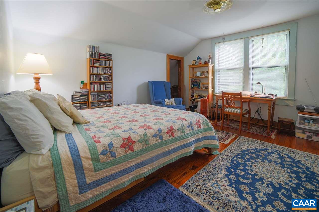 1139 Spencer Road Dillwyn, VA 23936 - Photo 5 of 29 a bedroom with a bed a table and a large window